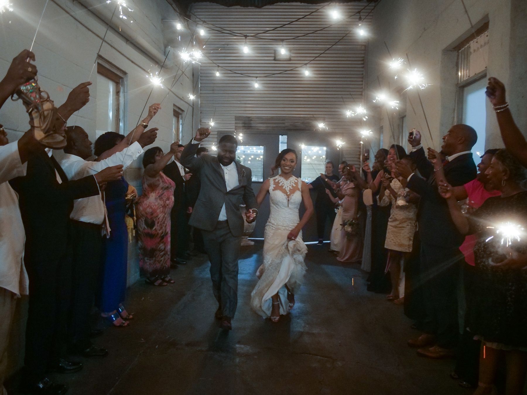 Sparkler send-off under string lights